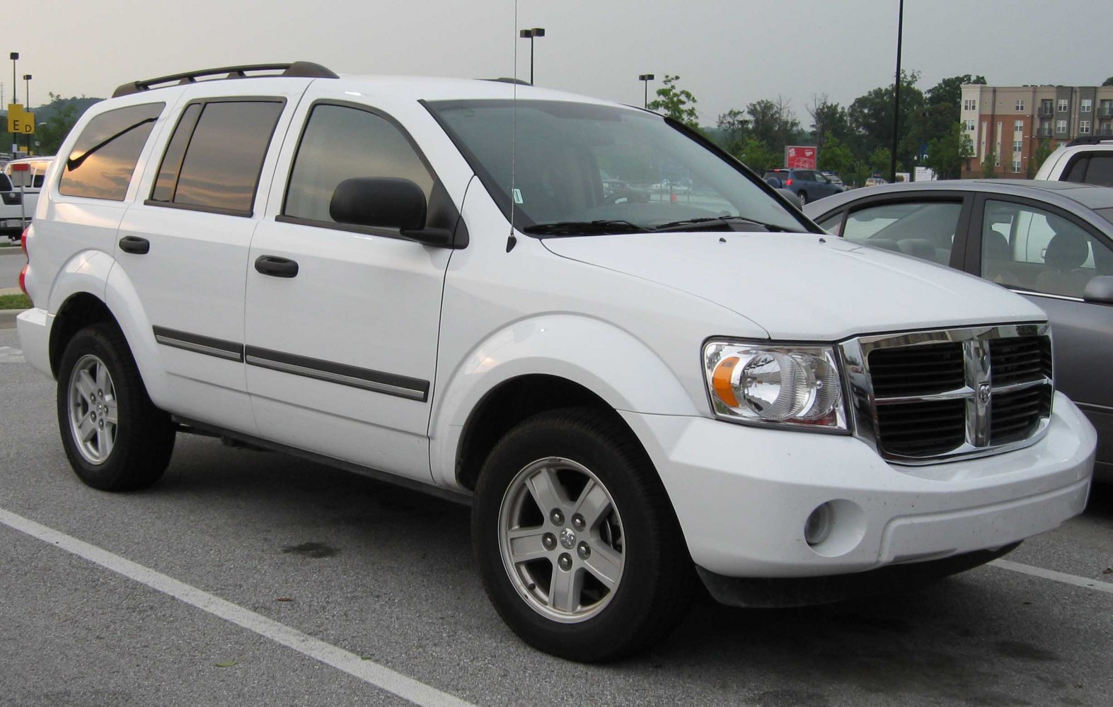 White SUV with prominent front grille and alloy wheels