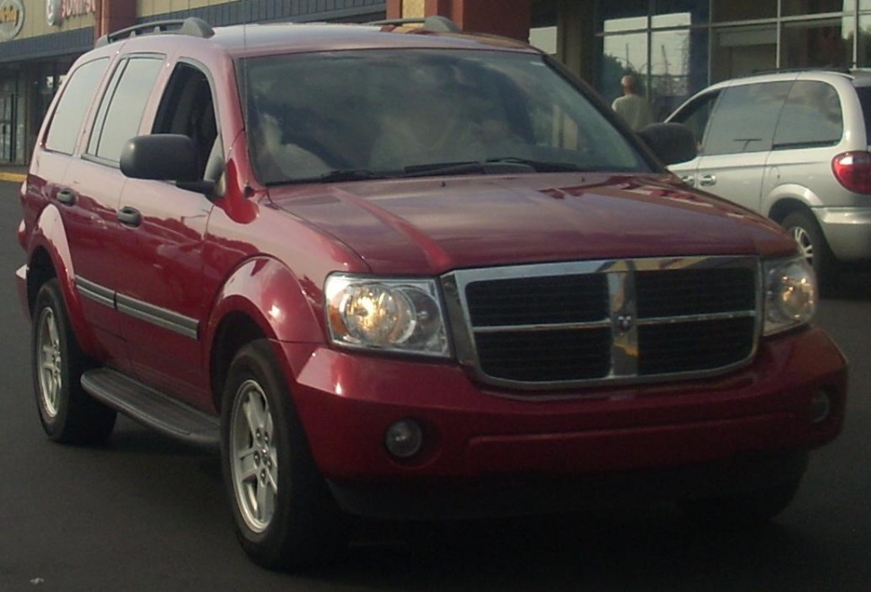 Front angled view of SUV with chrome grille and running boards