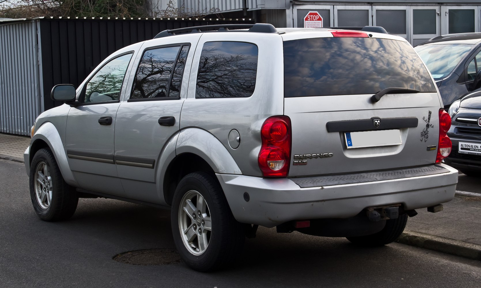 Rear and side view of mid-2000s SUV with tinted windows and tail lights