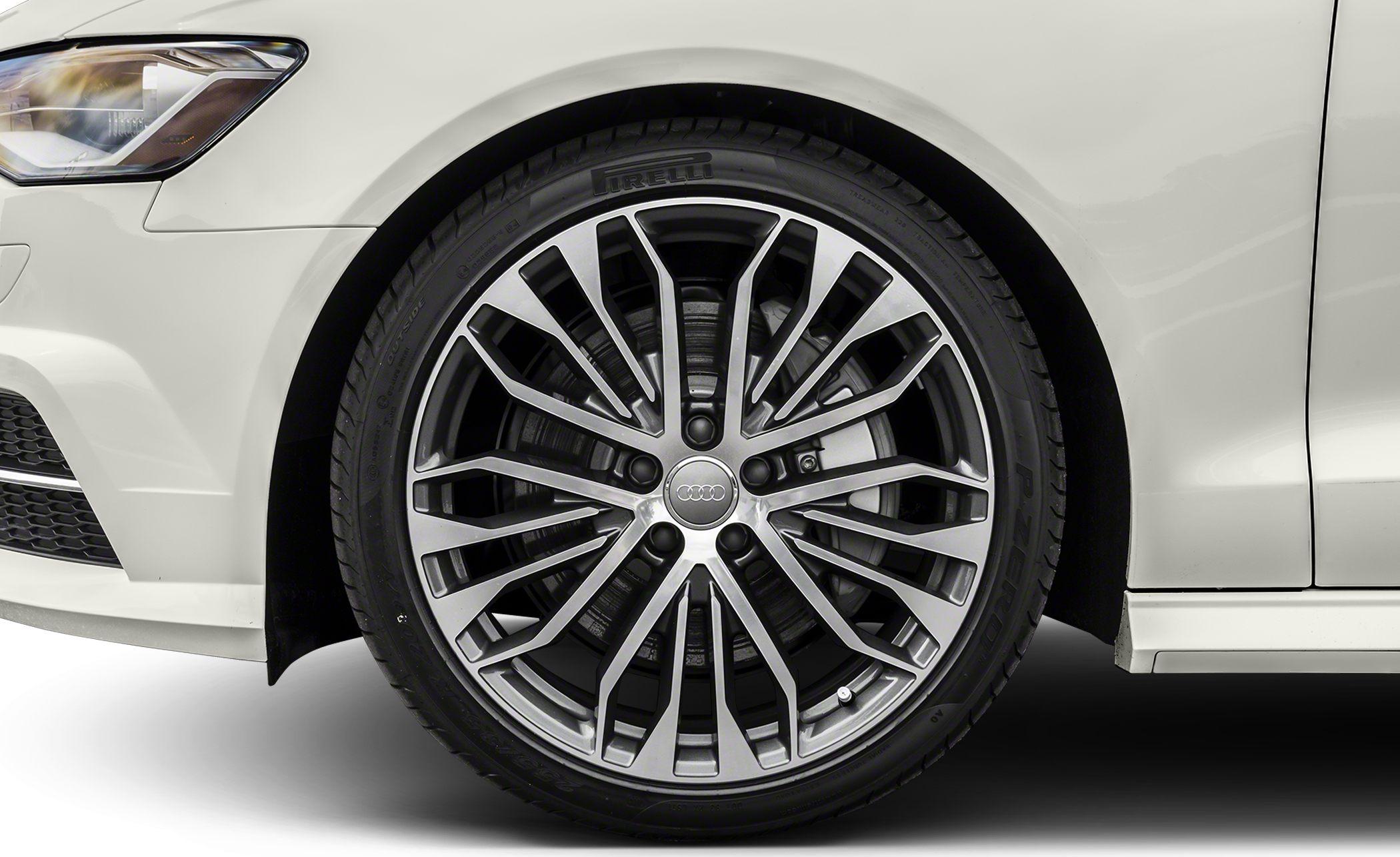 Modern multi-spoke alloy wheel with Pirelli tire on white car