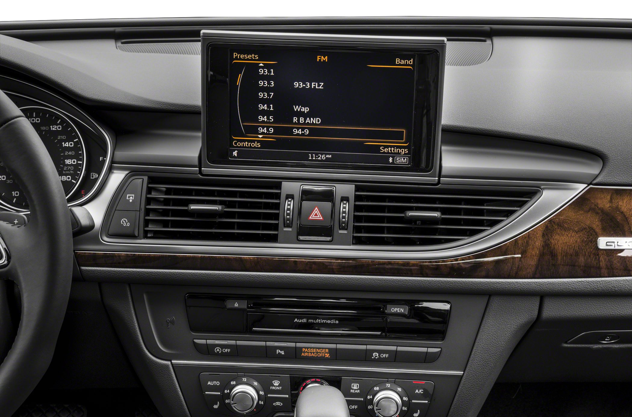 Multimedia touchscreen and climate control panel with wood trim and dashboard vents