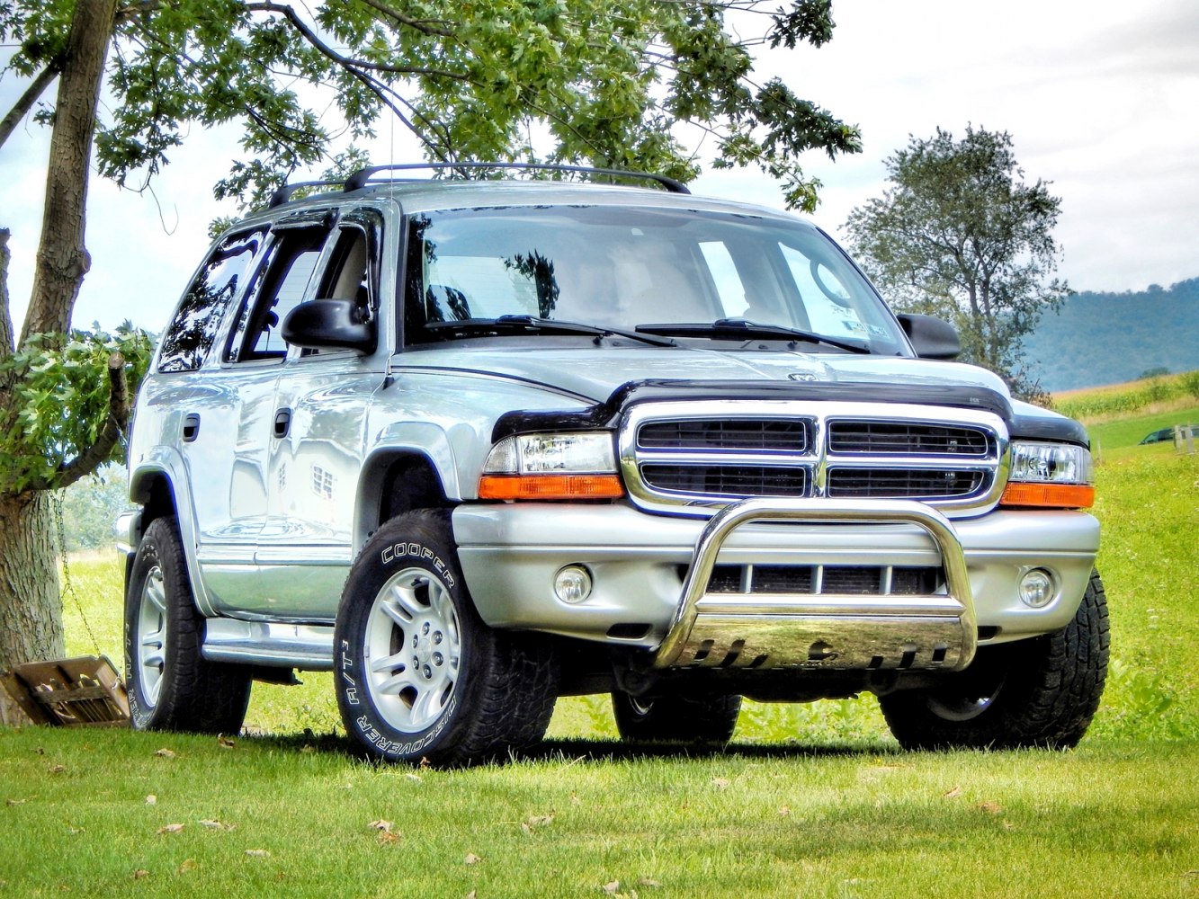 Front view of SUV with bull bar and off-road tires on grass