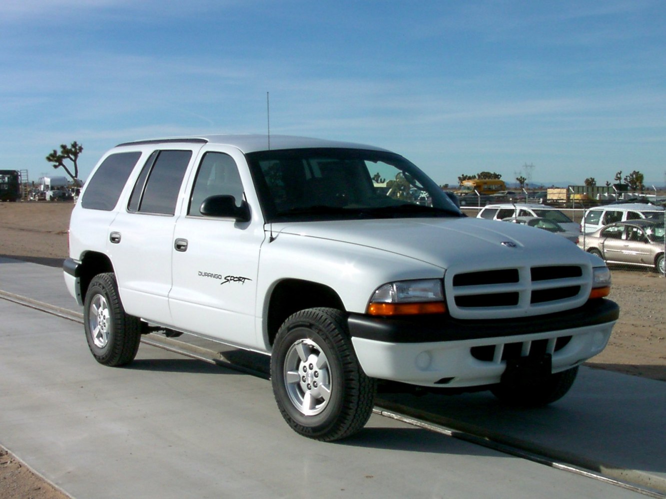 White sport SUV front and side view with distinct grill, wheels