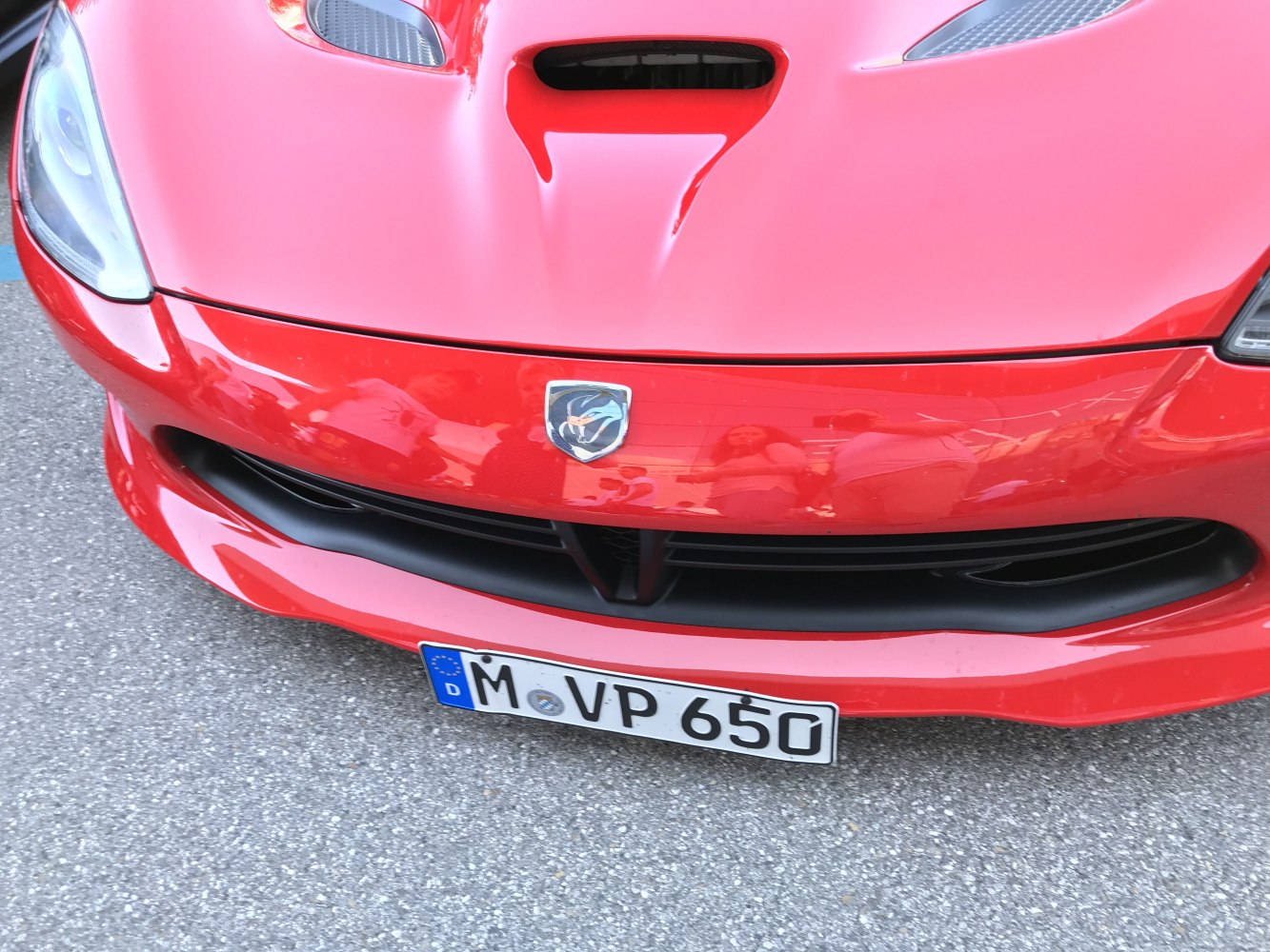 Front hood vent with car emblem and grille detail