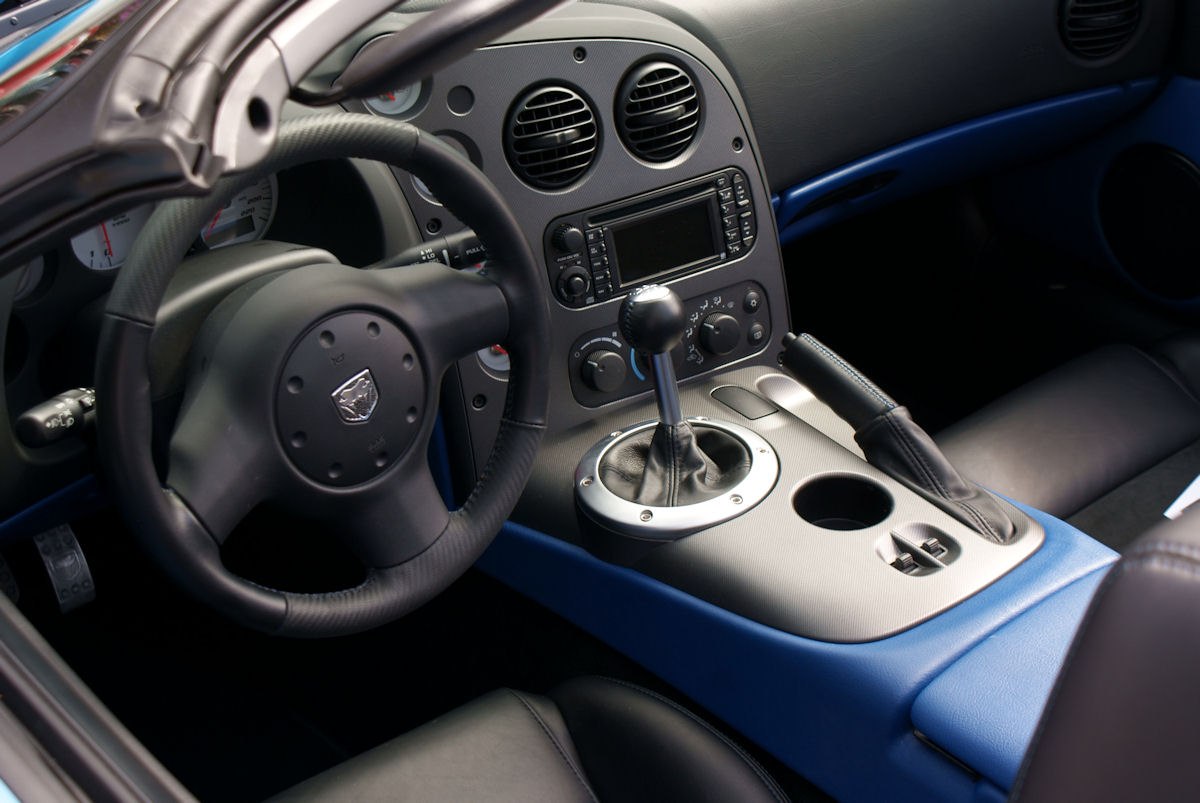Interior dashboard, steering wheel, and manual gear shift with center console