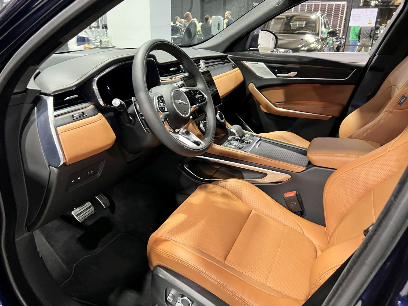 Luxury tan leather interior with modern dashboard and steering wheel