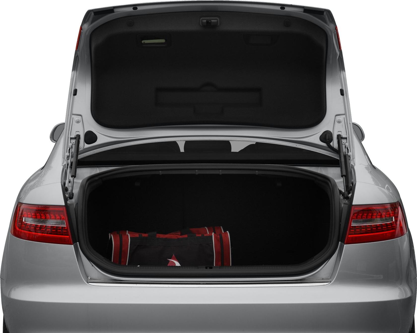 Open trunk of a silver sedan with visible luggage inside
