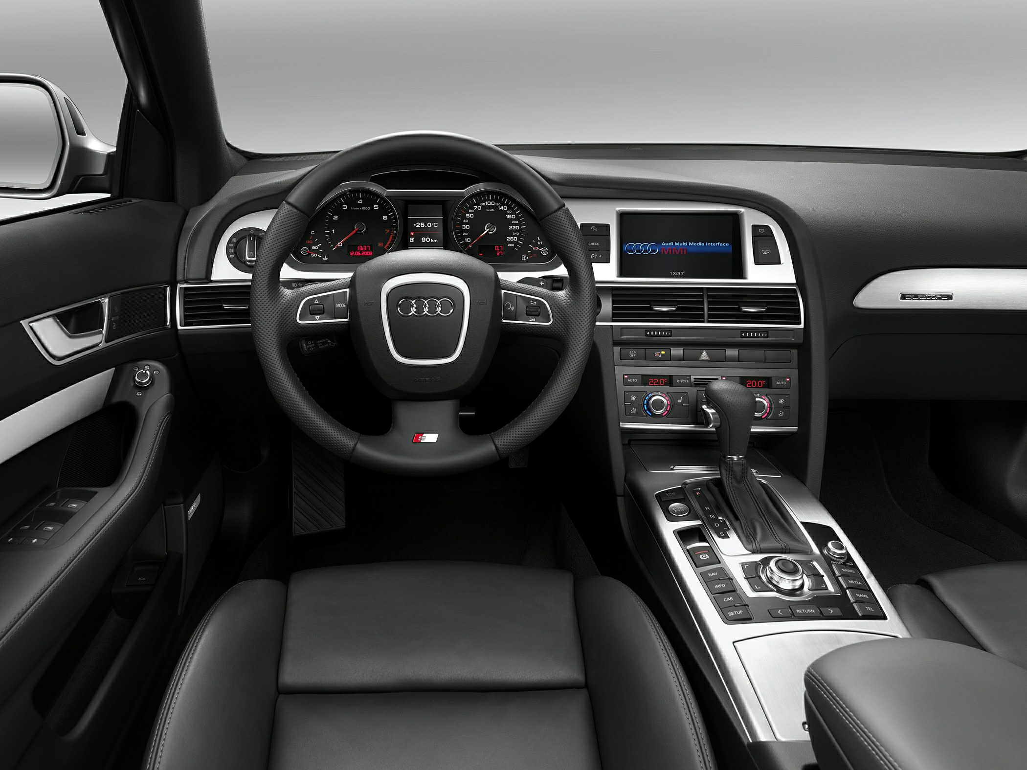 Steering wheel, digital dashboard, infotainment screen, center console controls.