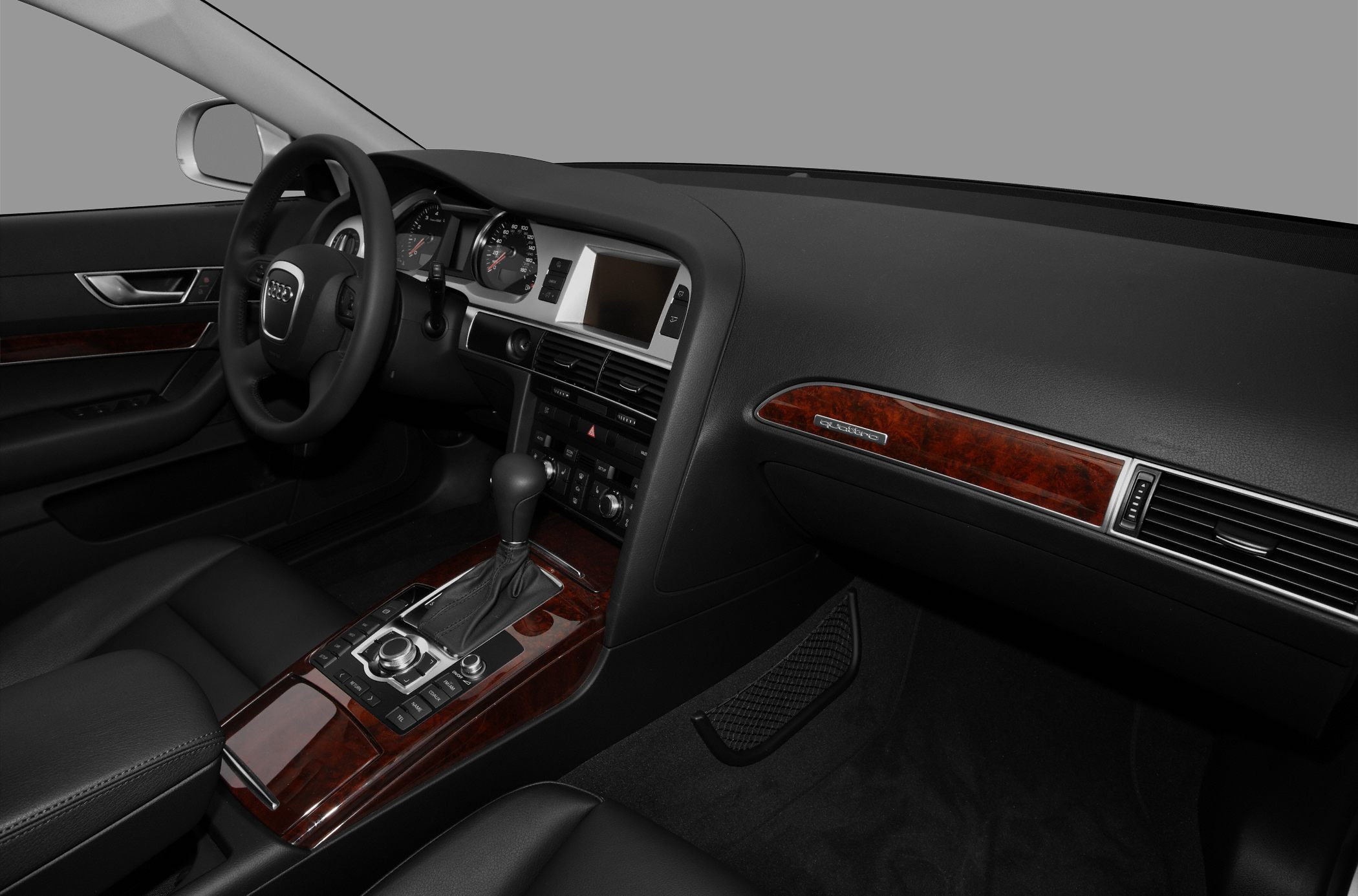 Audi A6 dashboard, steering wheel, and wooden central console trim