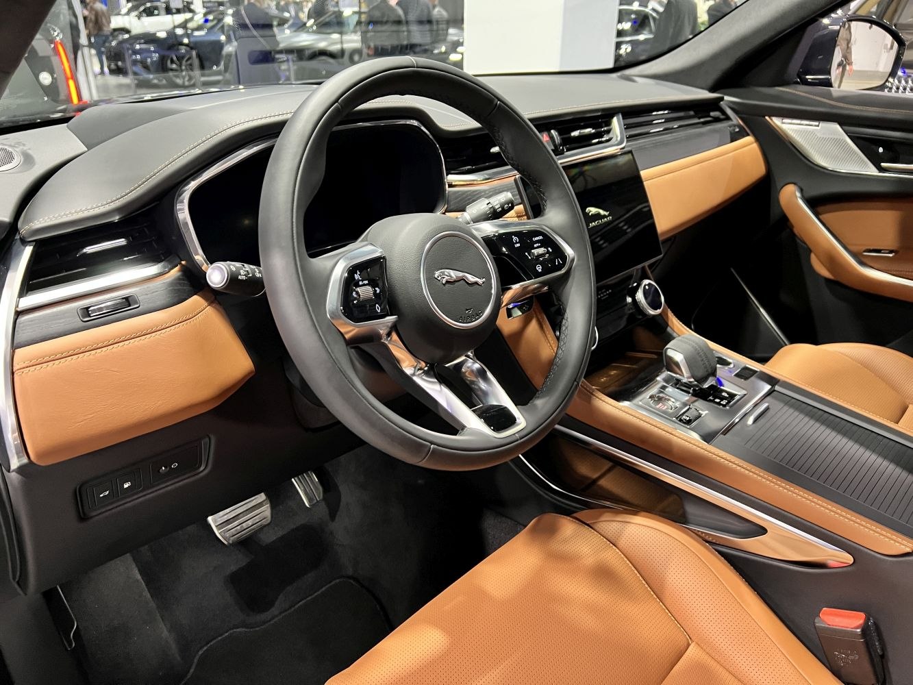 Luxury SUV interior with leather seats, digital cluster, touchscreen display.
