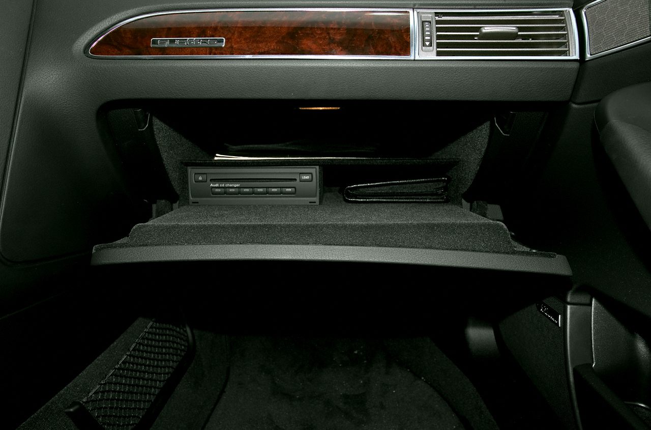 Open glove box with CD changer and wood trim panel
