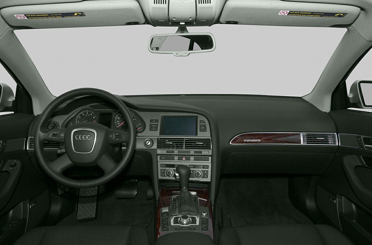 Interior dashboard and steering wheel with central console and wood trim