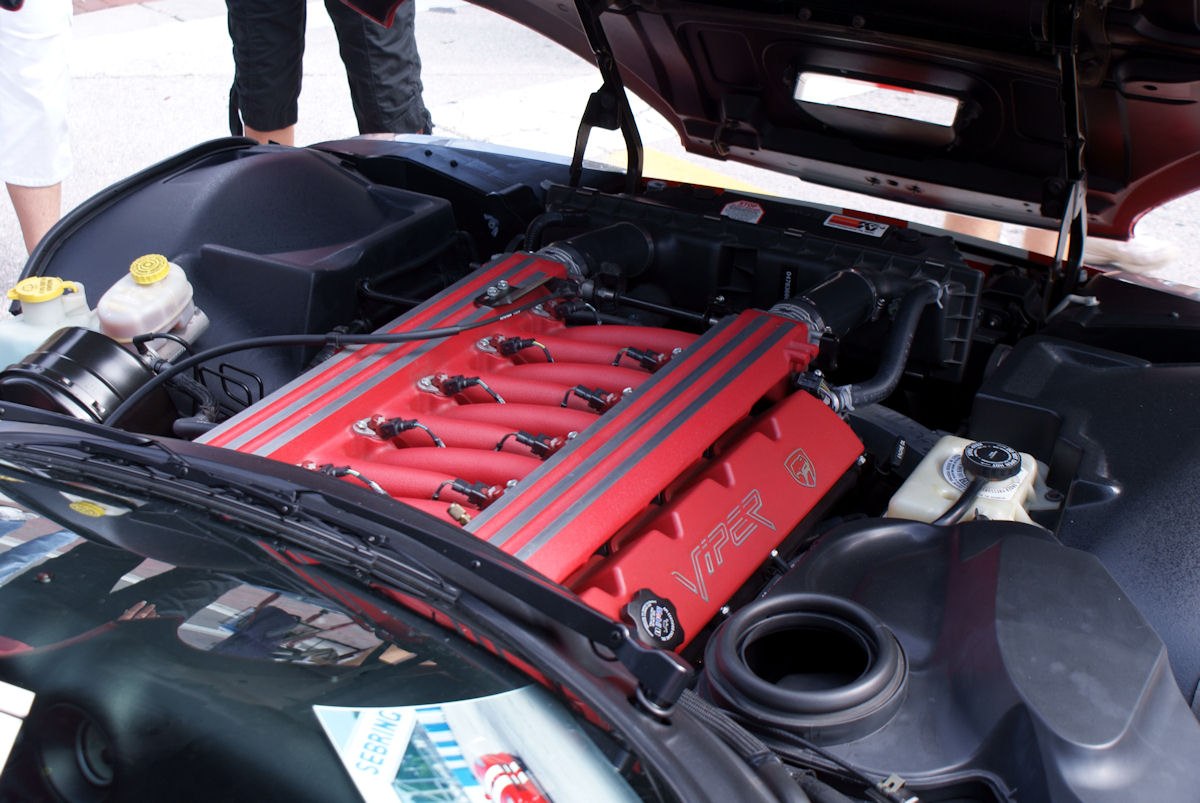 Red V10 engine with dual black stripes under open hood