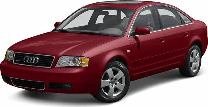 Red four-door sedan with five-spoke alloy wheels, front side angle