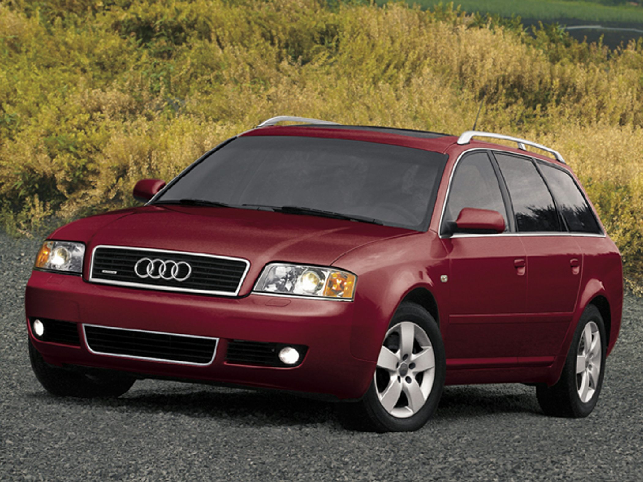 Red station wagon front side view with roof rails and alloy wheels