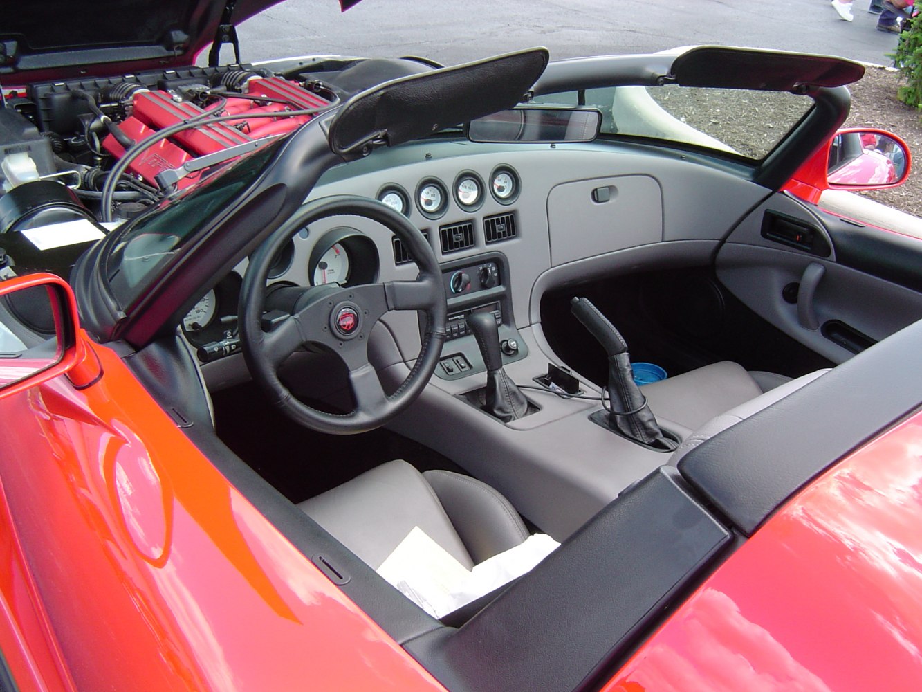 Convertible sports car interior with leather seats and visible V10 engine