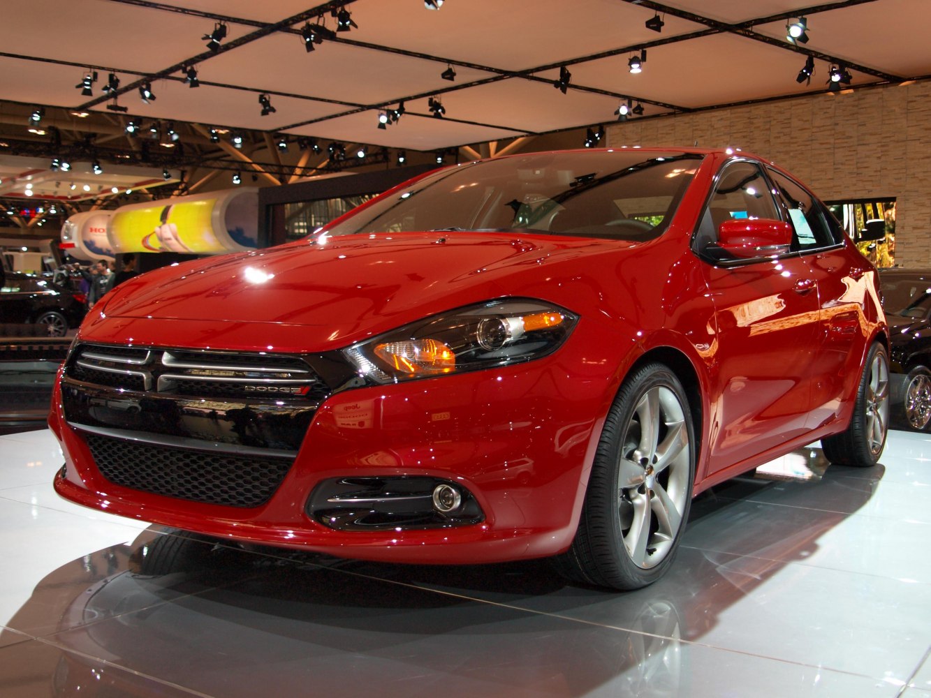 Front angle with sleek grille, headlights, alloy wheels