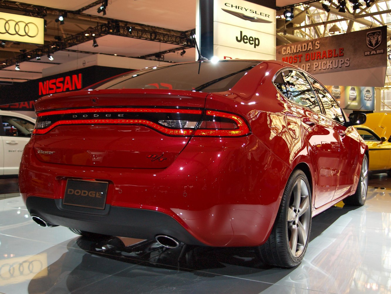 Rear view of red sedan with continuous tail light and dual exhaust