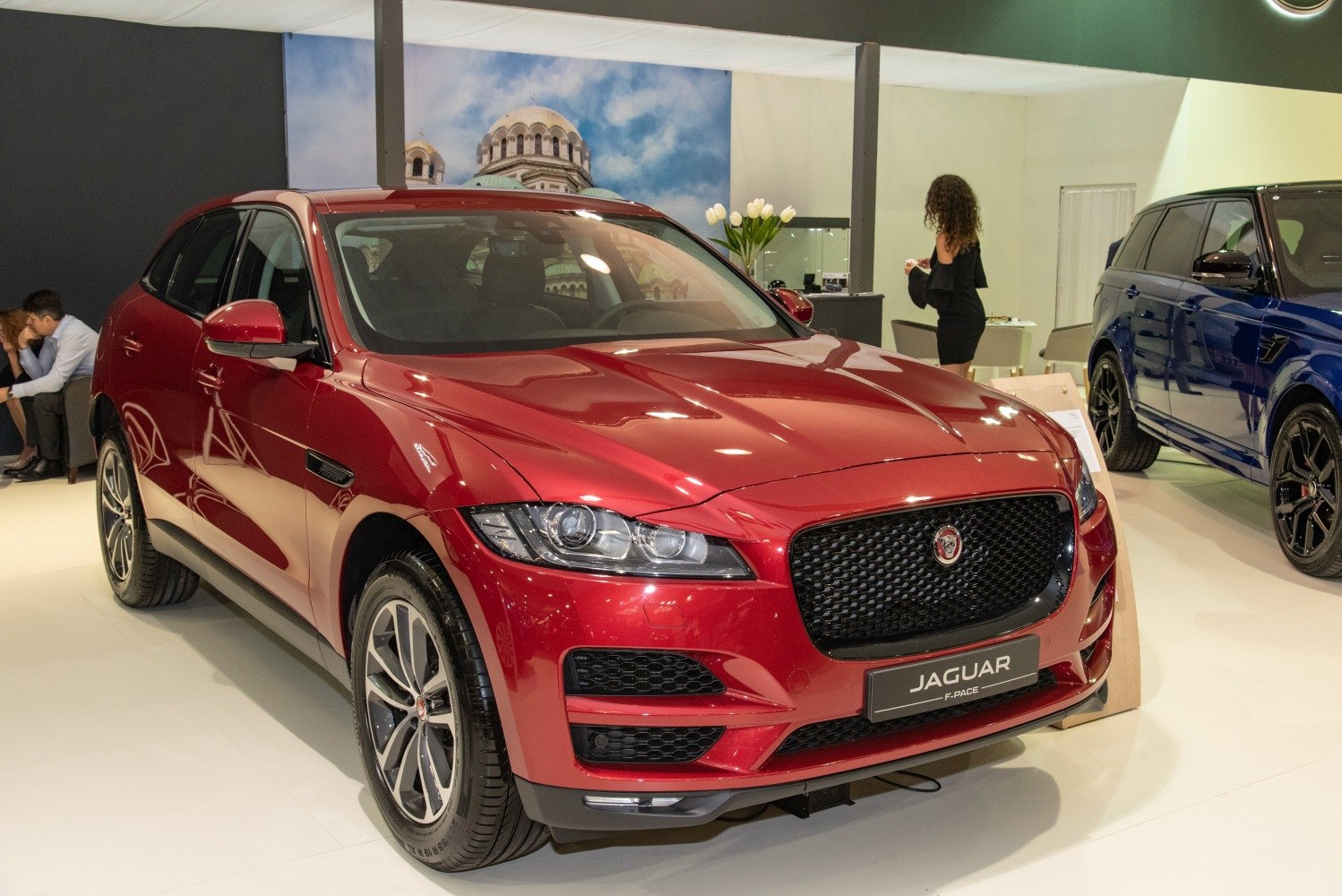 Front view of red luxury SUV with prominent grille and headlights