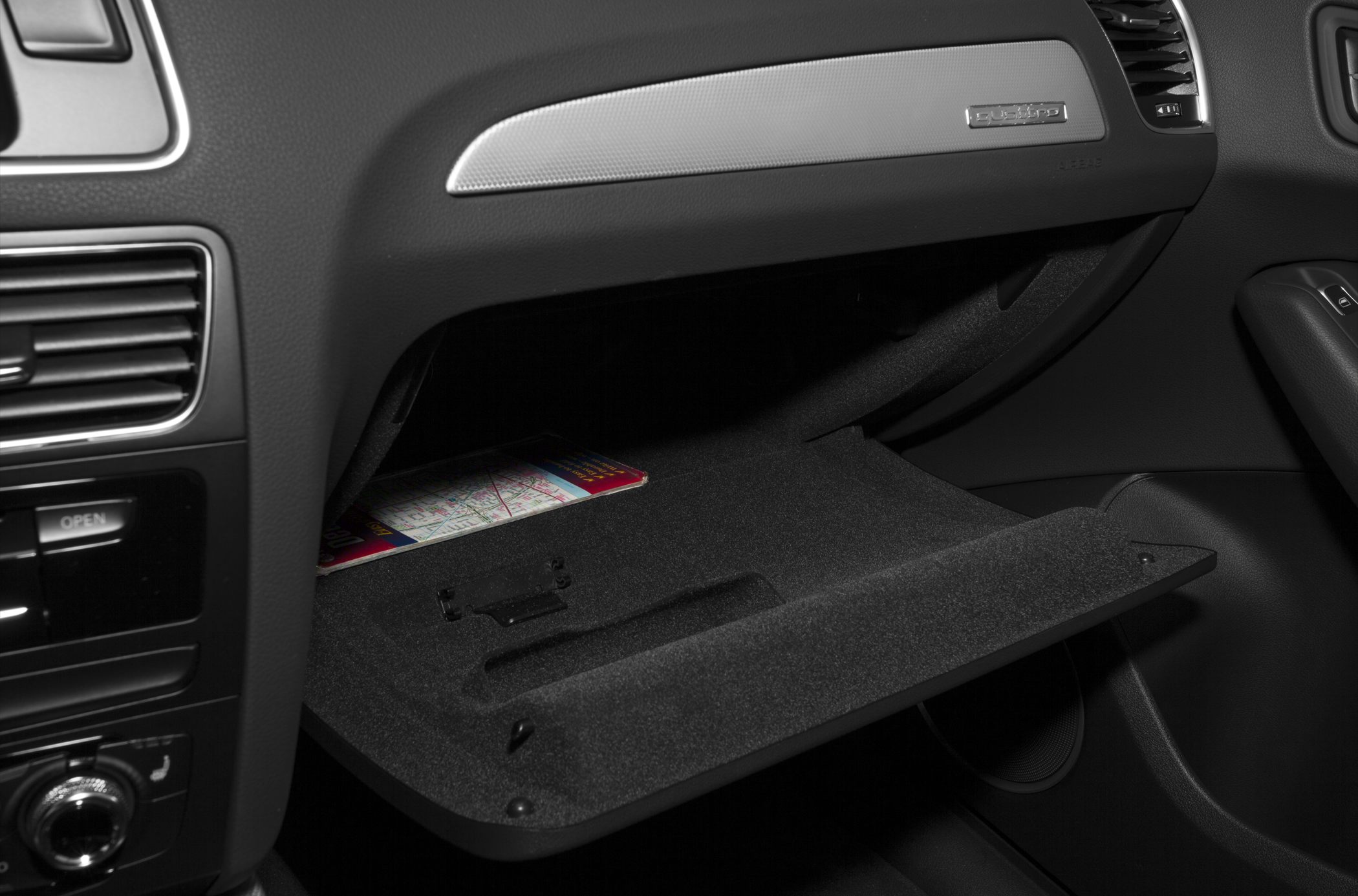 Car interior glove compartment with textured lining and map storage