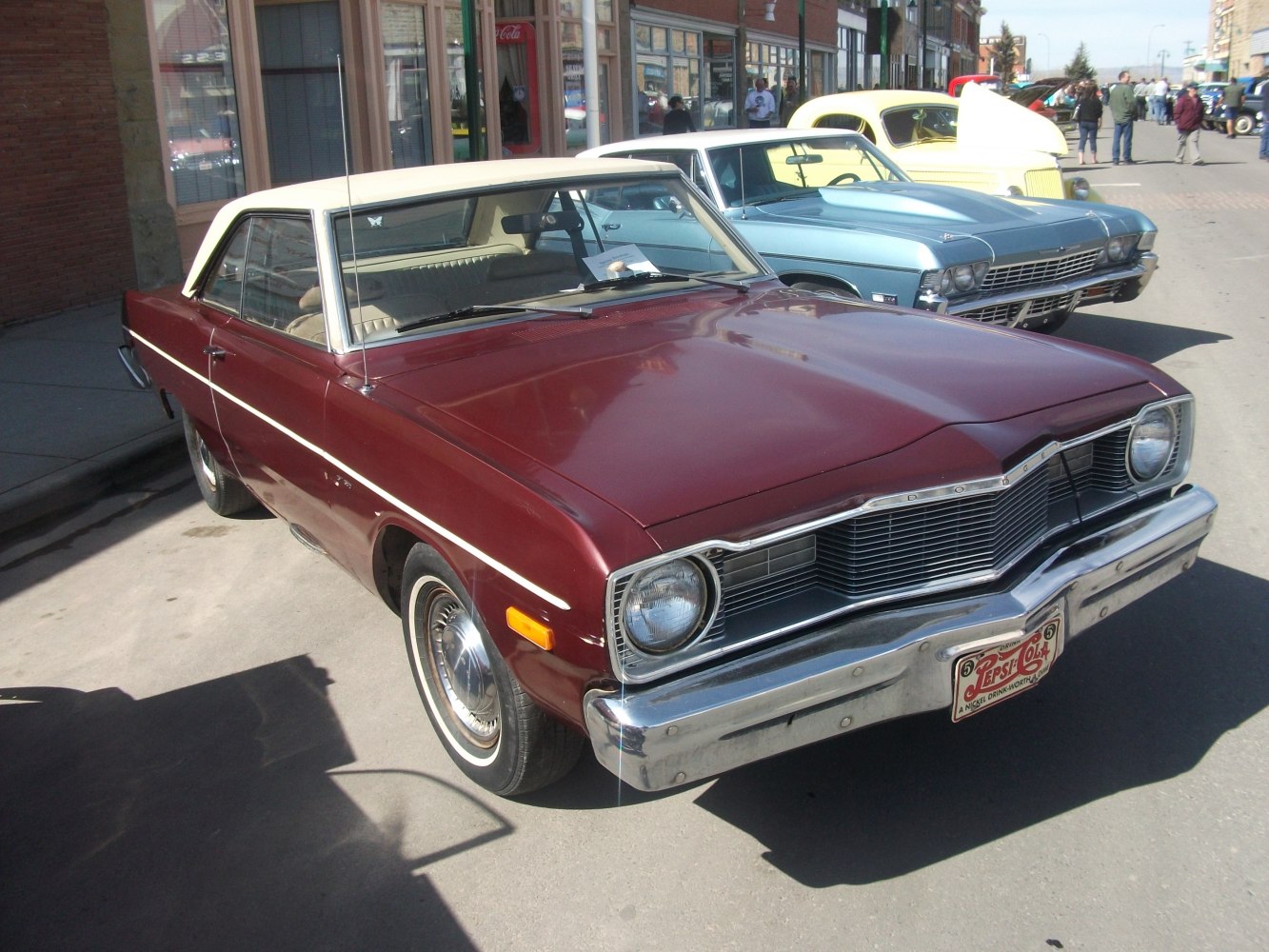 Vintage hardtop with round headlights and classic chrome bumper.