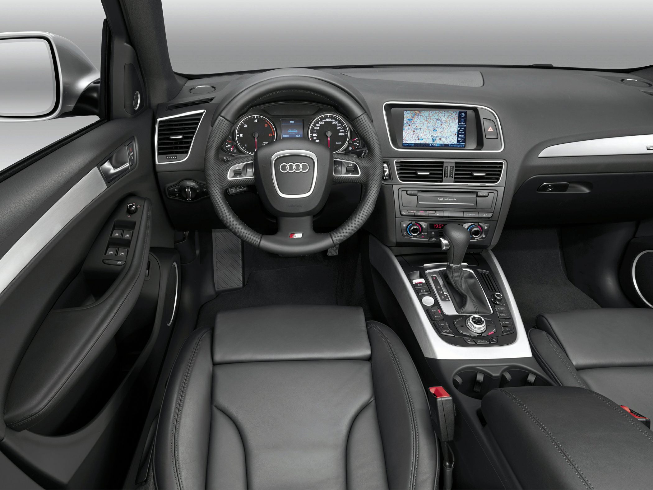 Dashboard and steering wheel with multimedia control and leather seating.