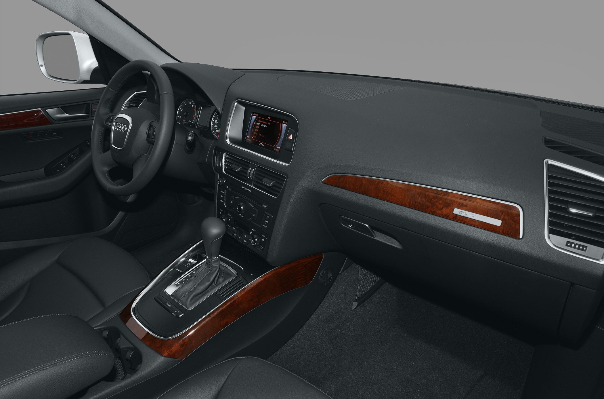 Luxury car interior with wood trim dashboard and automatic gear shift