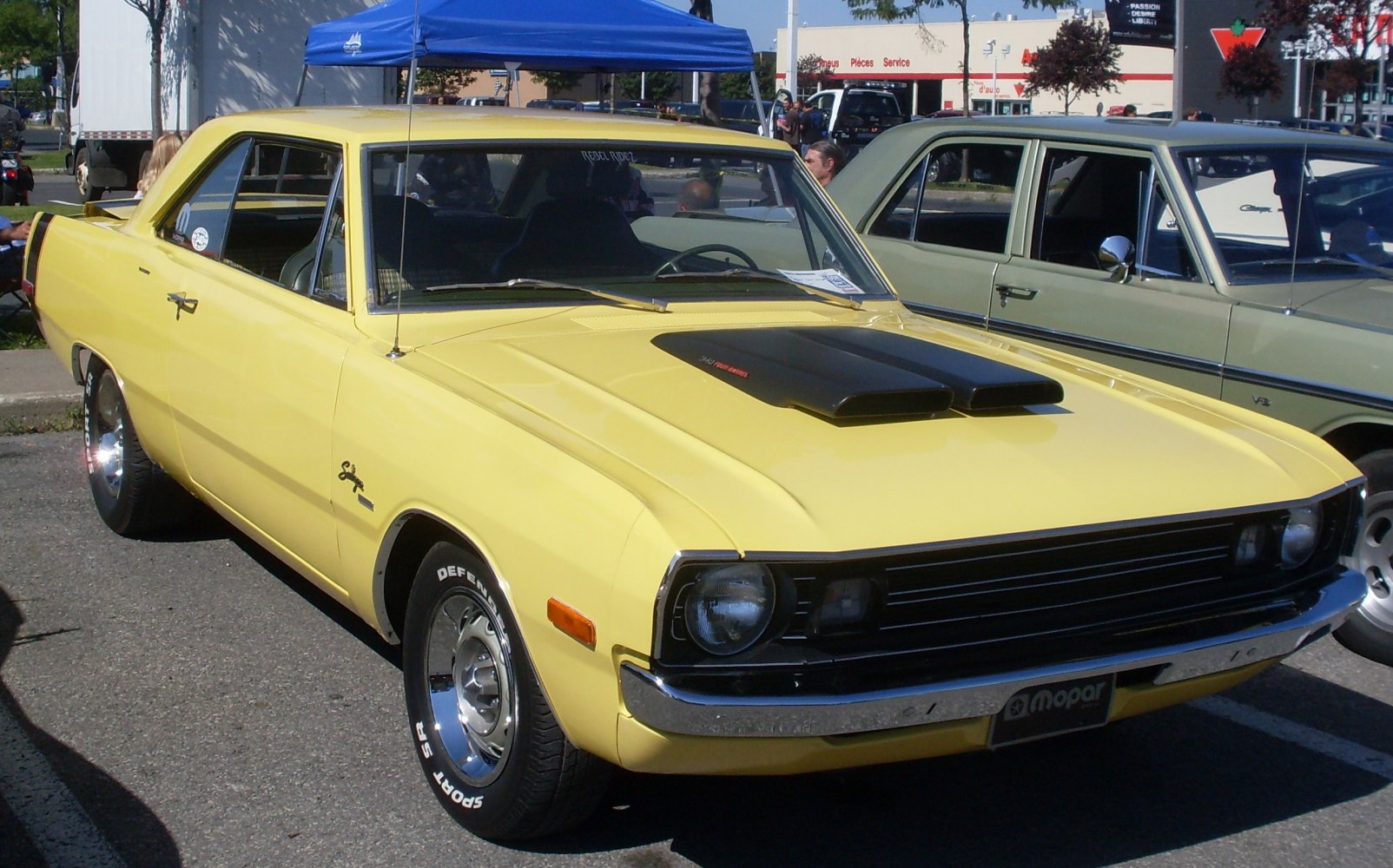 Yellow hardtop coupe with black dual-snorkel hood scoop and vintage styling