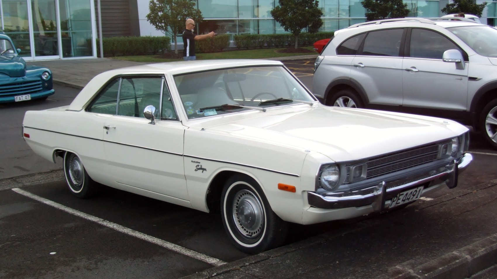 Side and front view of a vintage hardtop coupe with distinctive rectangular headlights.