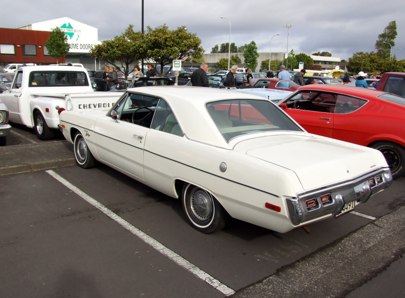 Rear 3/4 view of white hardtop coupe with classic taillights and clean lines