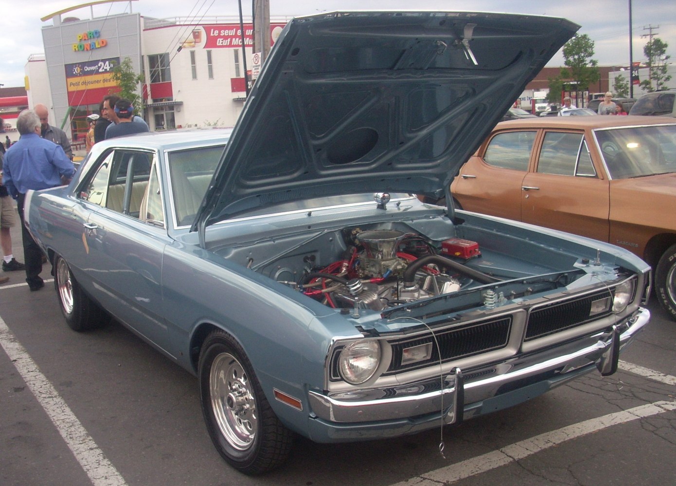 Classic hardtop coupe with open hood showcasing engine details