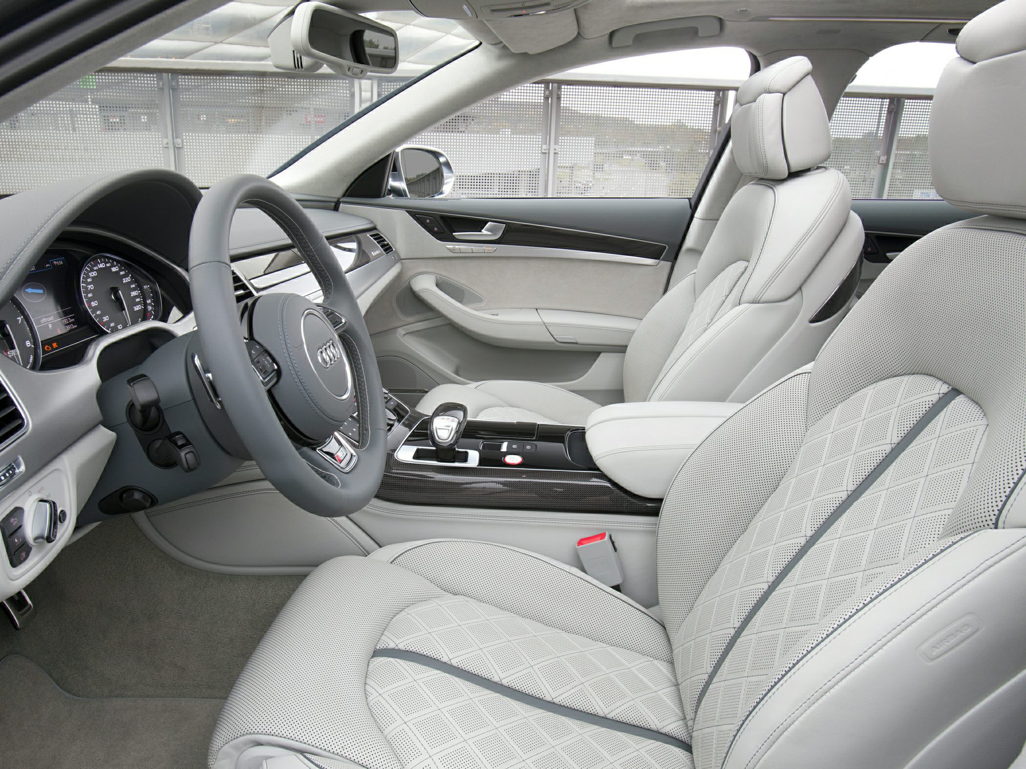 Luxurious leather seats with diamond stitching and modern dashboard.