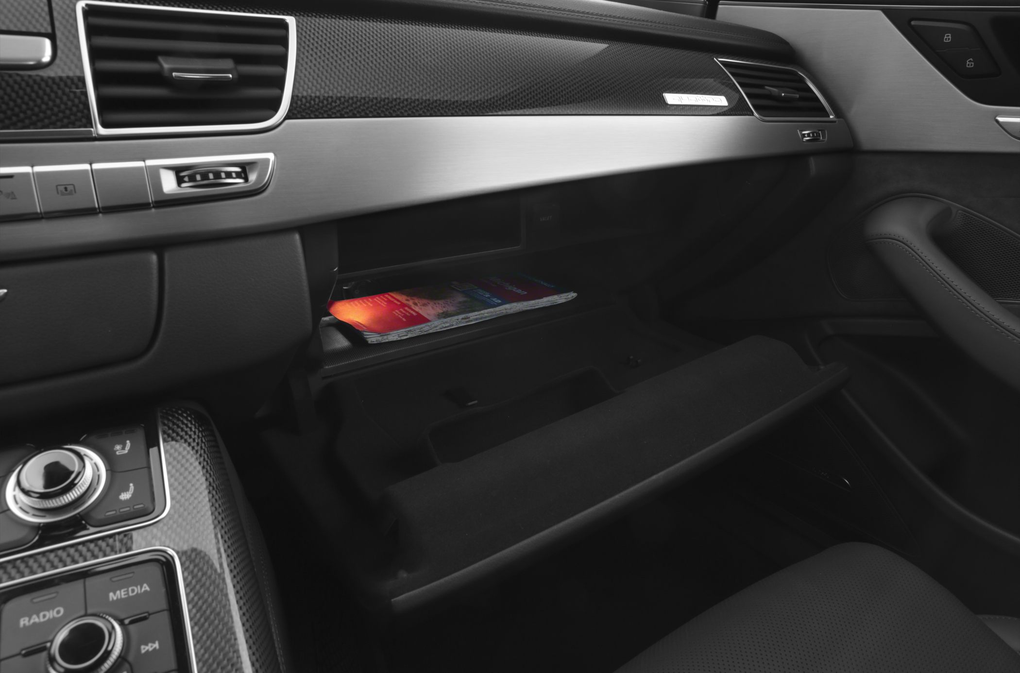 Illuminated glove compartment with carbon fiber dashboard trim