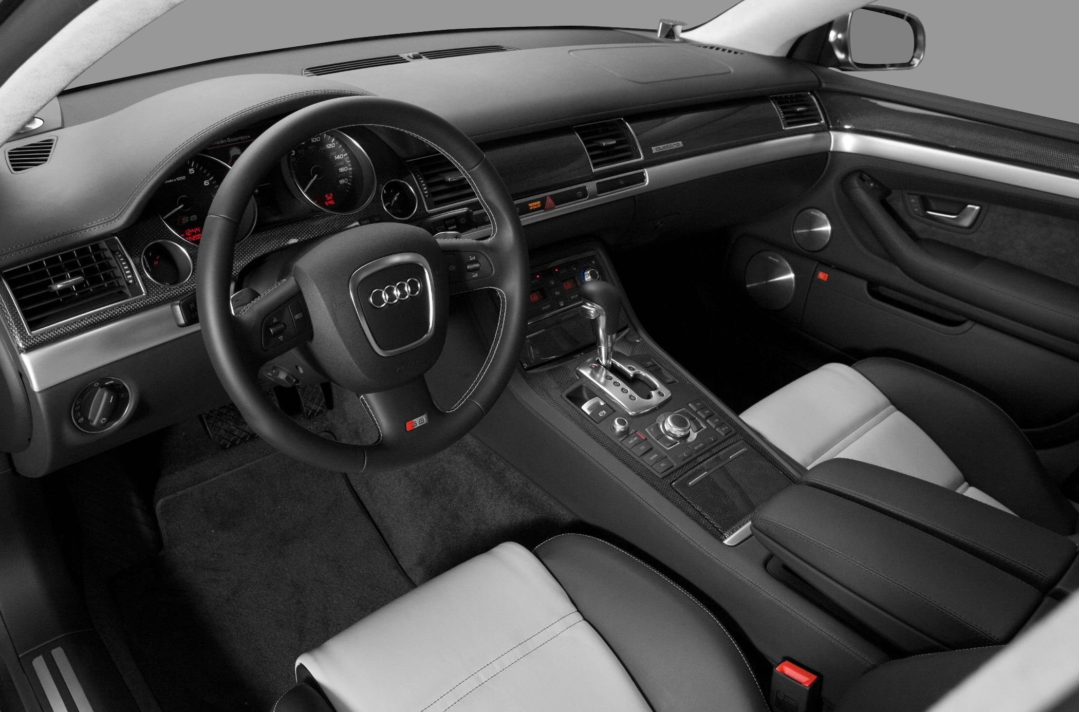 Luxury interior with detailed dashboard, steering wheel, and center console controls