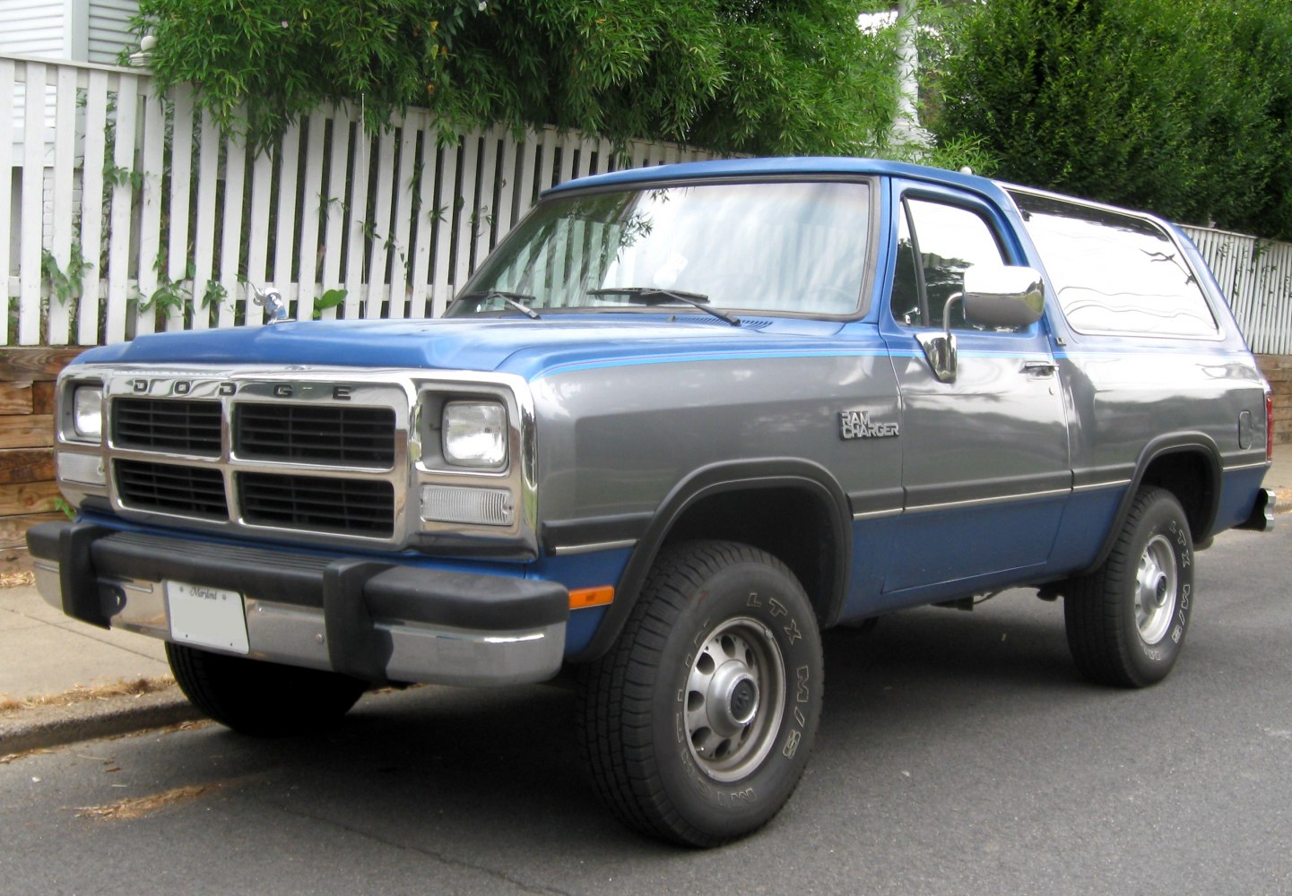 Two-tone blue-and-gray SUV front side view with chrome grille.