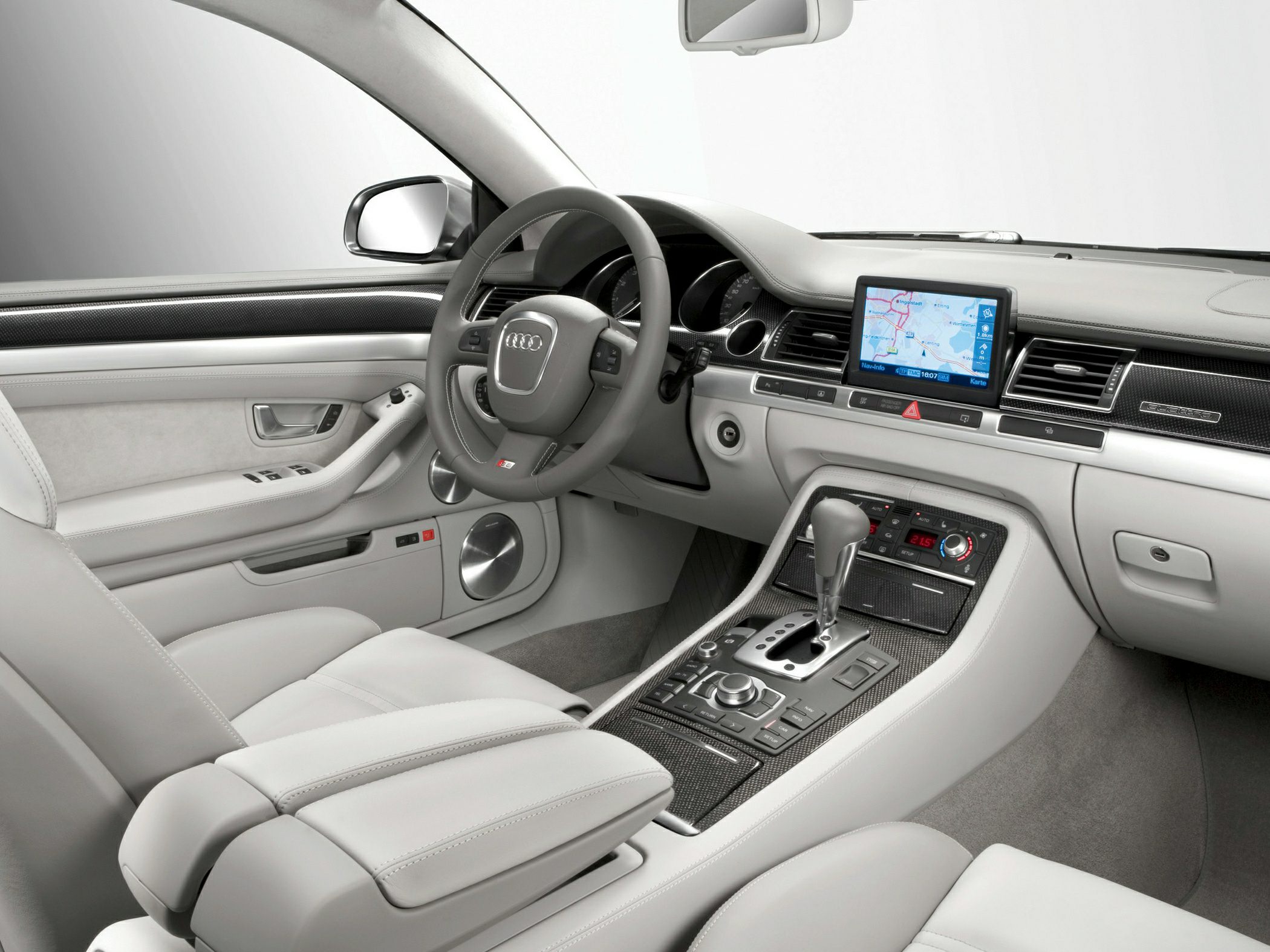 Luxury car interior with navigation screen and carbon fiber trim