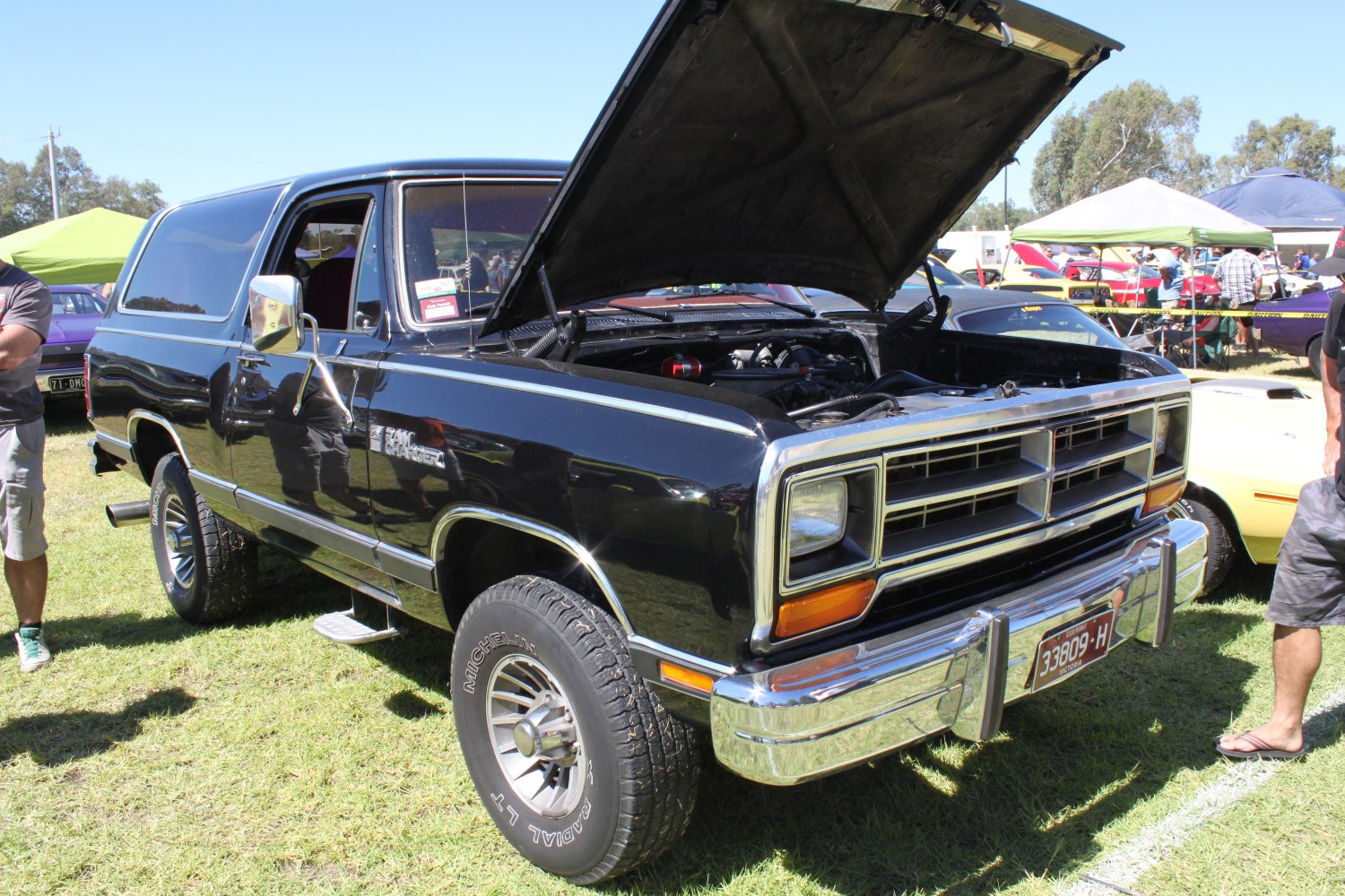 Open hood front view of classic SUV with off-road tires