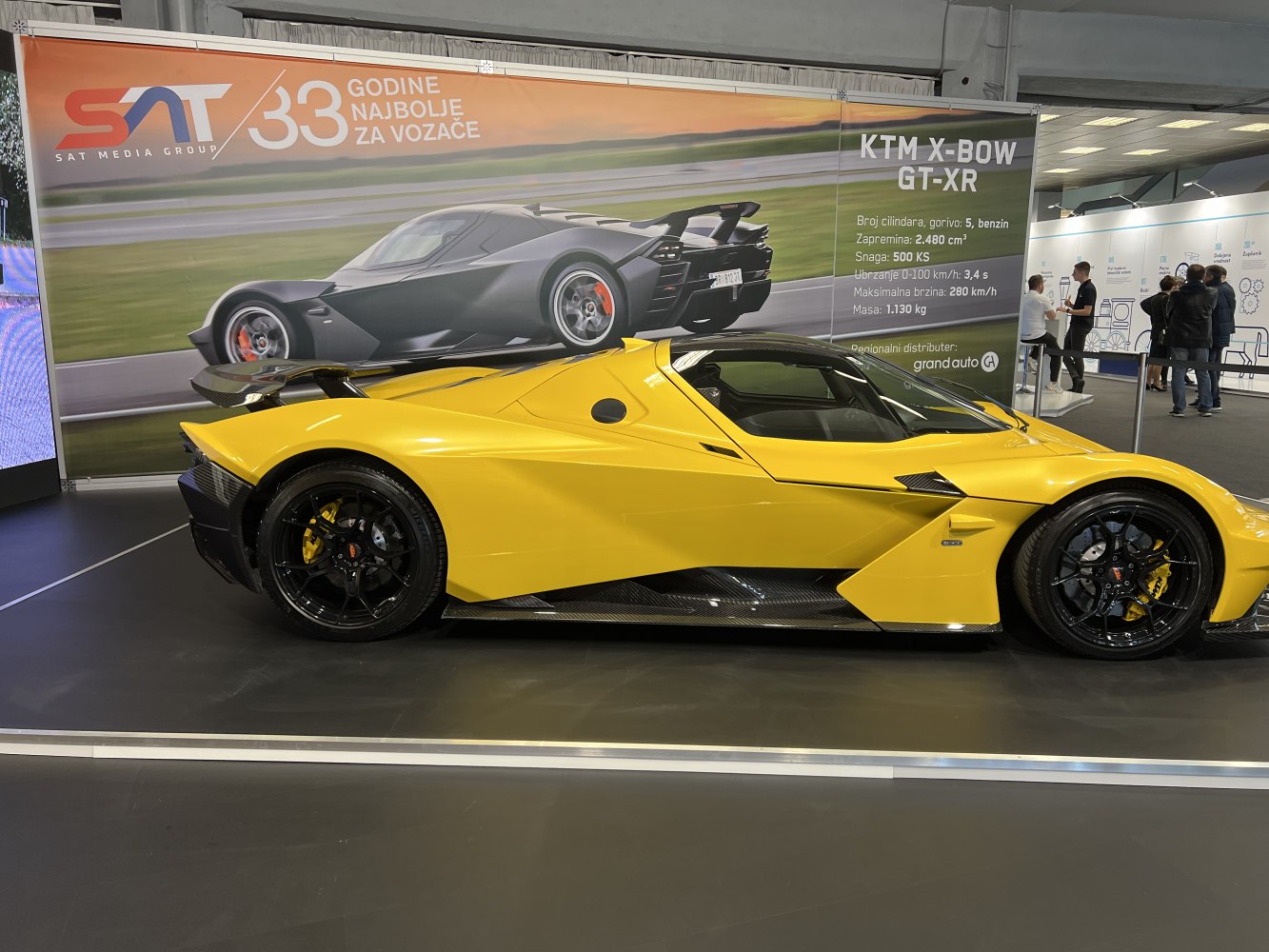 Side profile of a yellow sports car with aerodynamic body and prominent rear wing