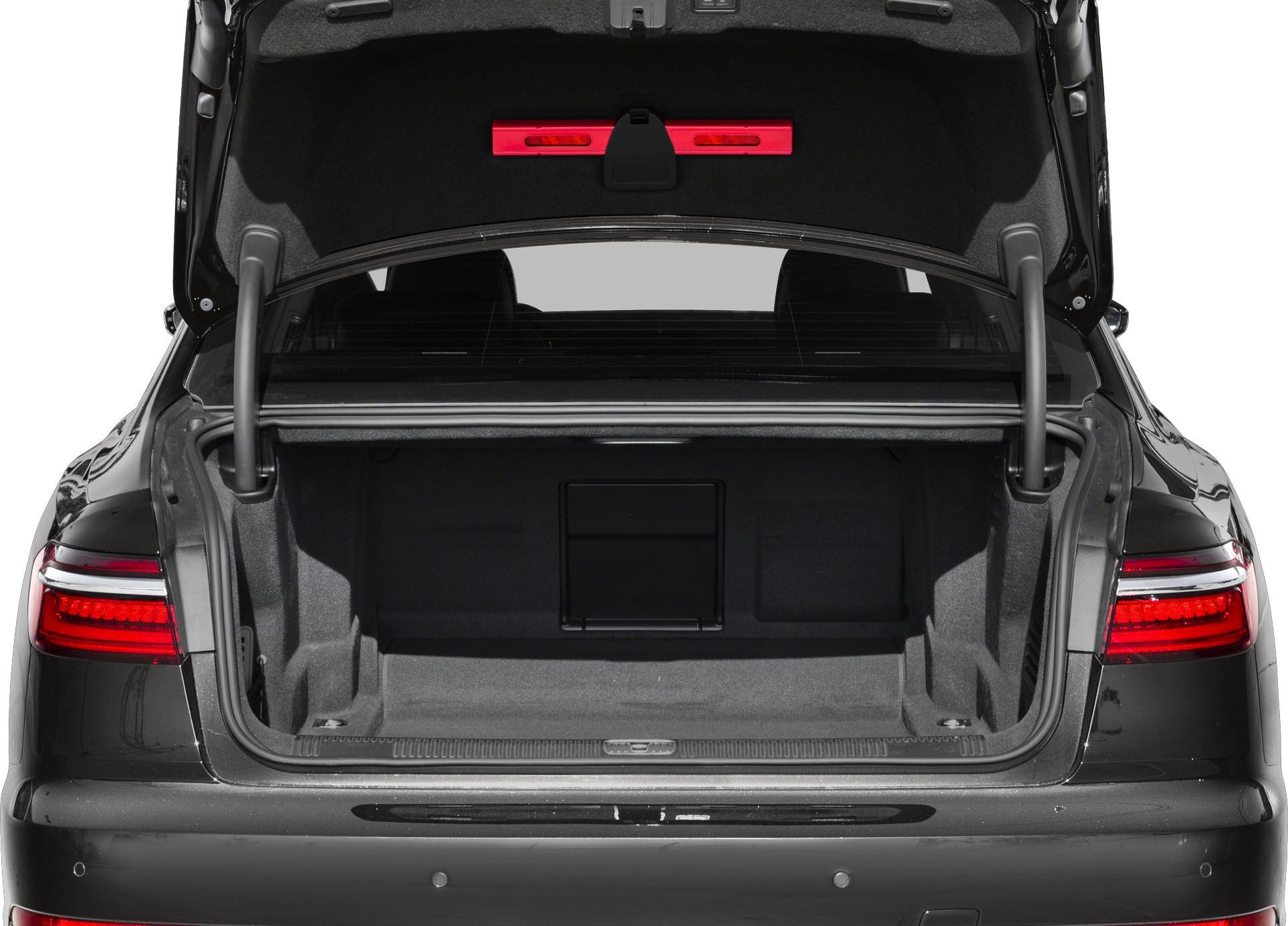Open trunk showing spacious interior and taillights of a luxury sedan.