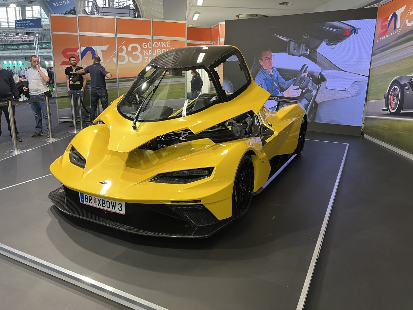 Yellow sports car with a canopy-style upward opening door.