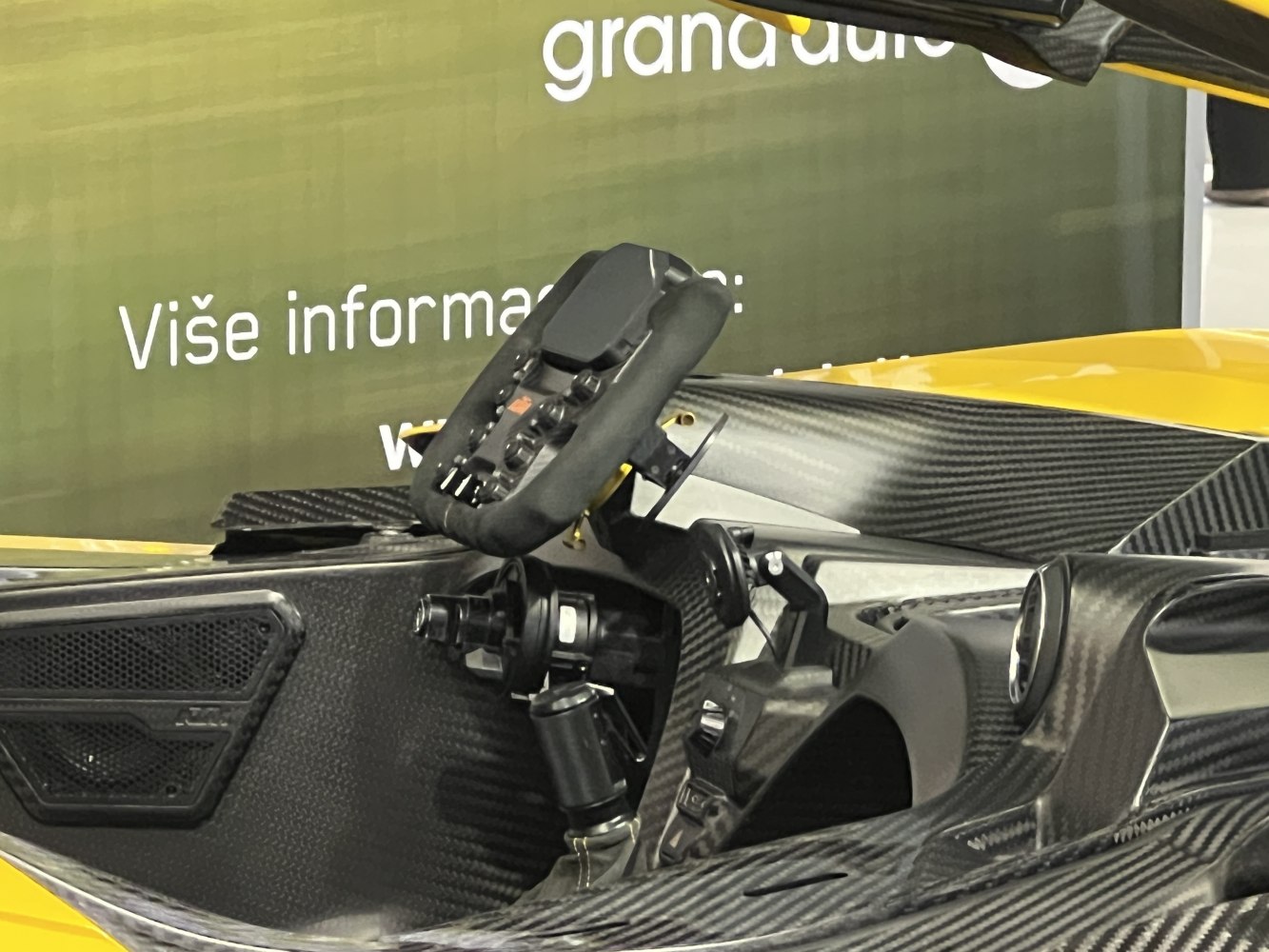 Racing-style steering wheel and carbon fiber cockpit interior