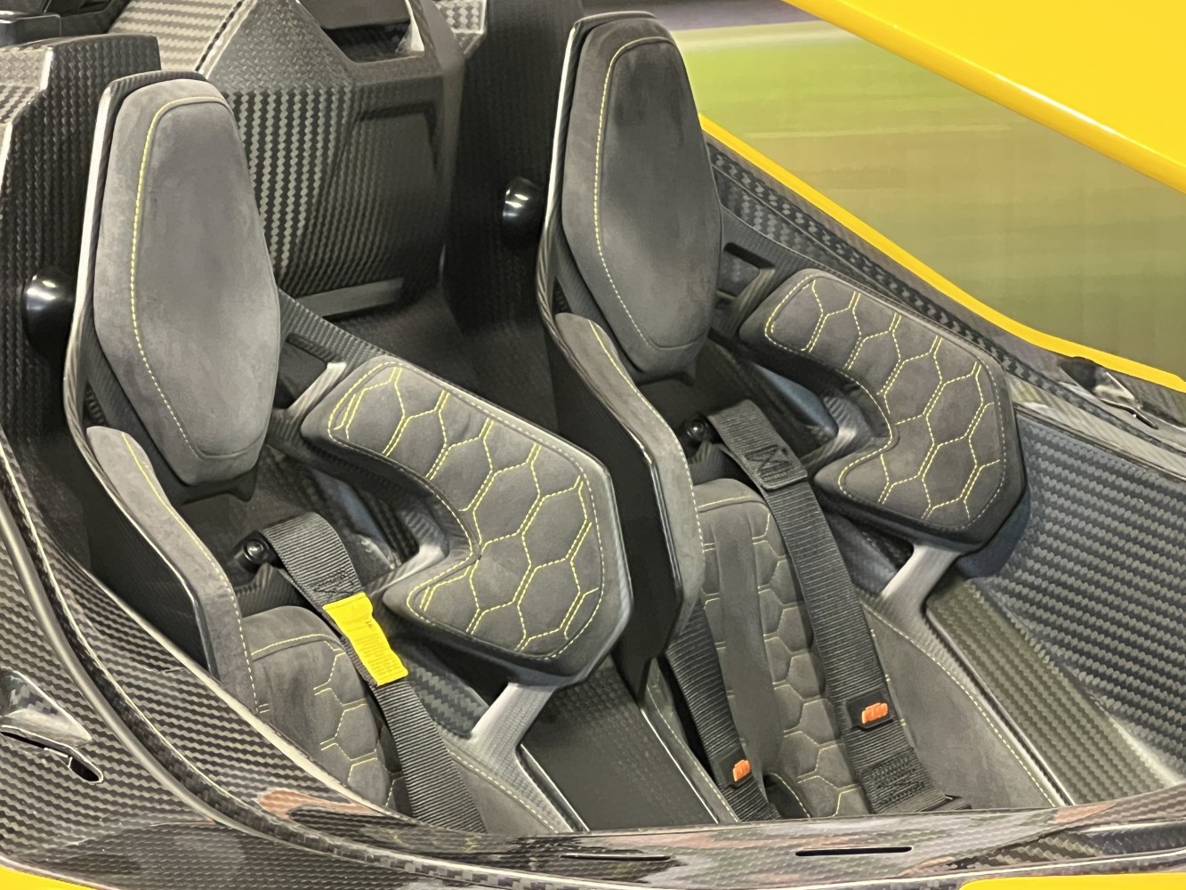 Carbon fiber interior with racing bucket seats and harnesses