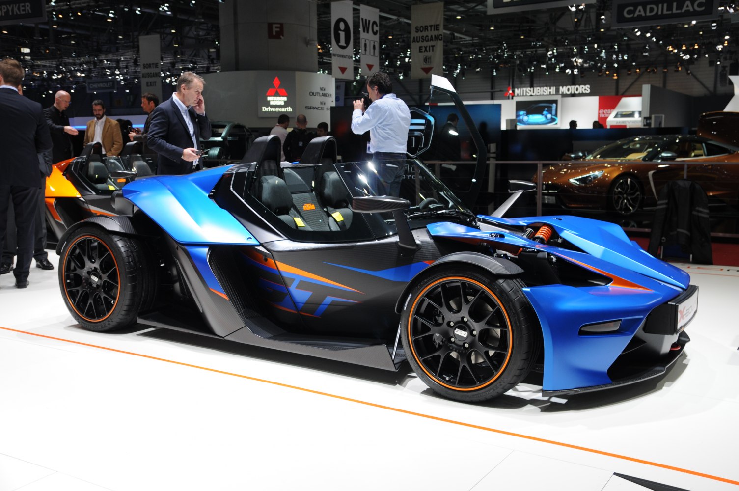 Open roof lightweight sports roadster with exposed suspension and aerodynamic body.