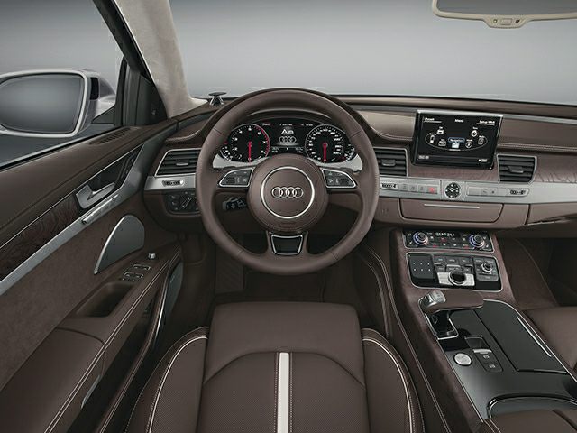 Leather steering wheel, digital dashboard, and infotainment system in luxury sedan interior