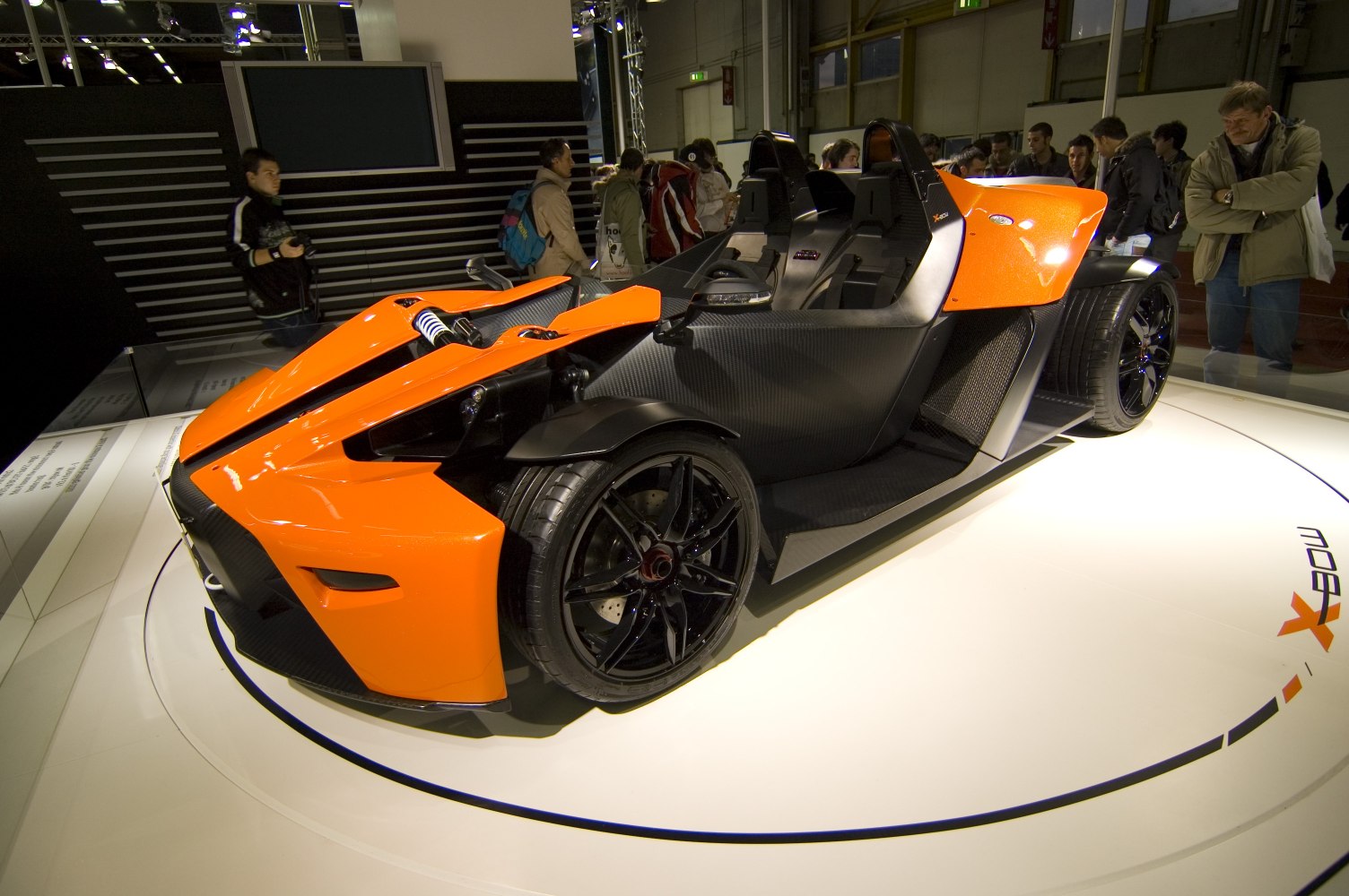 Open-top lightweight sportscar with exposed suspension and dual racing seats