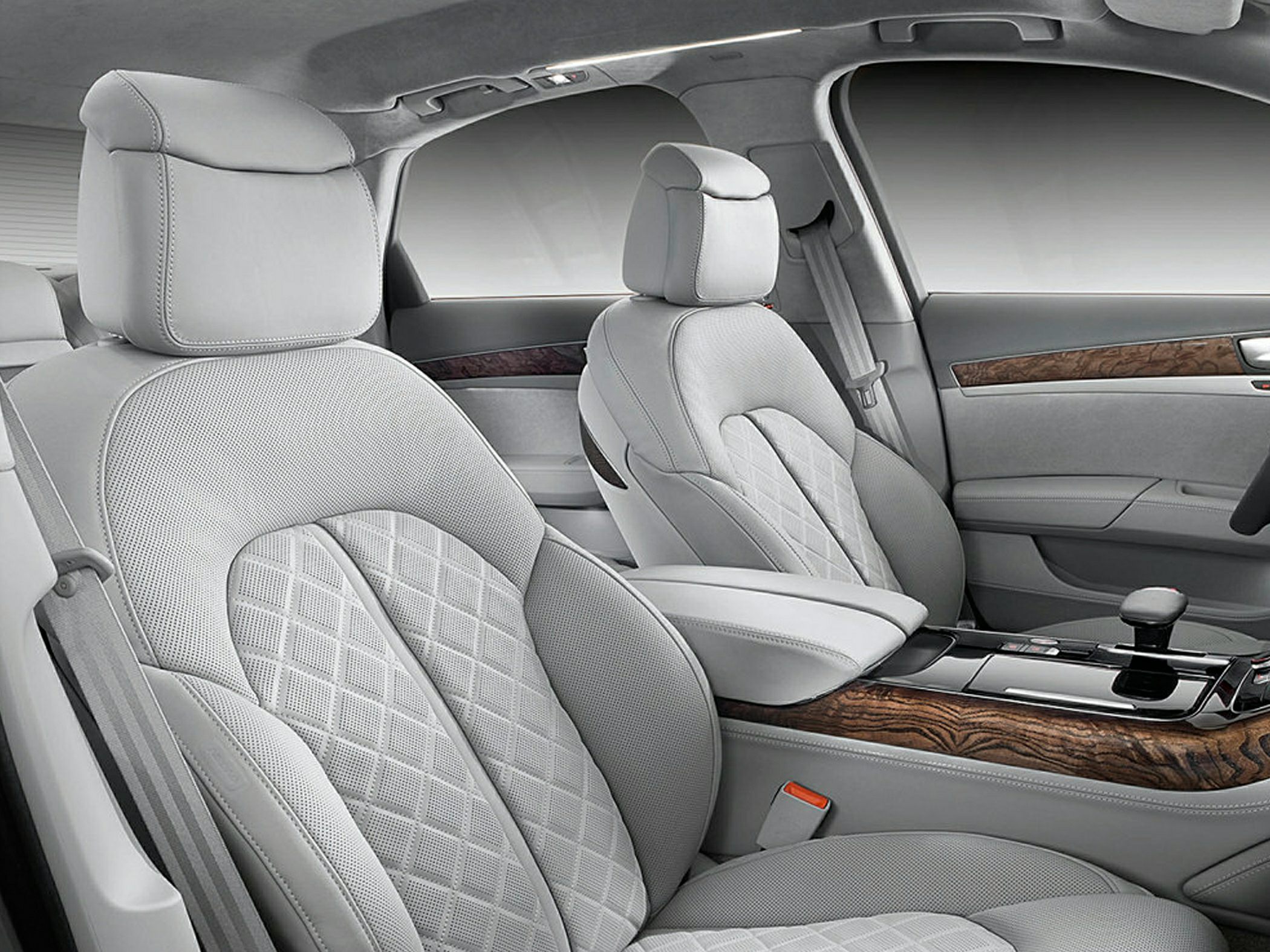 Quilted leather seats and wood trim in luxury car interior