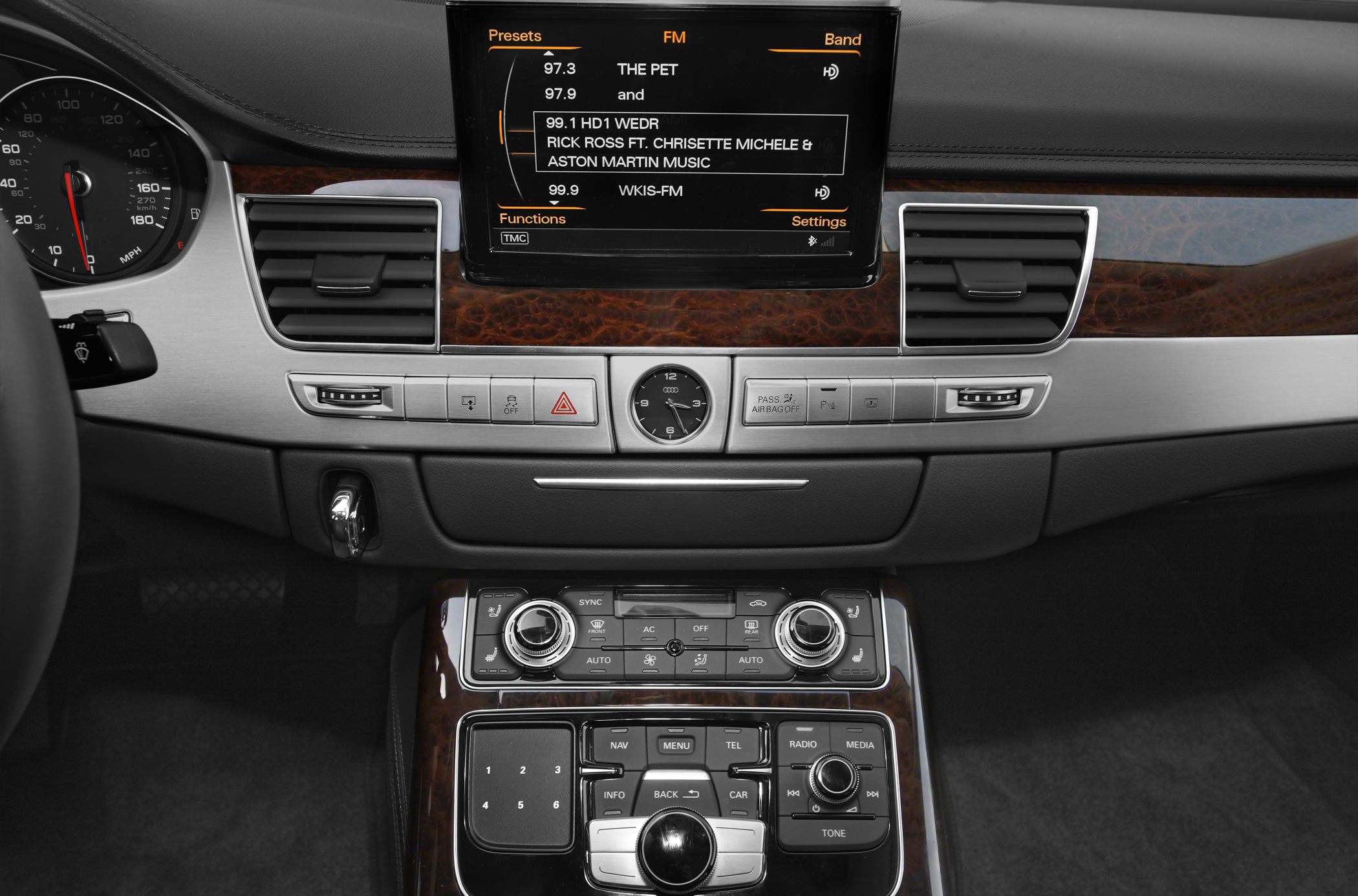 Dashboard with analog clock and infotainment controls