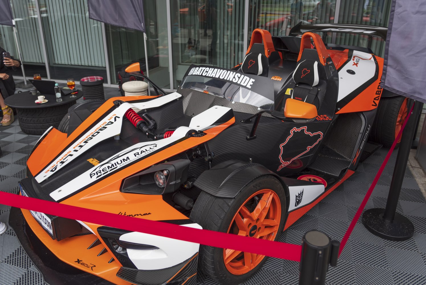 Exposed front suspension and racing cockpit with vibrant orange accents