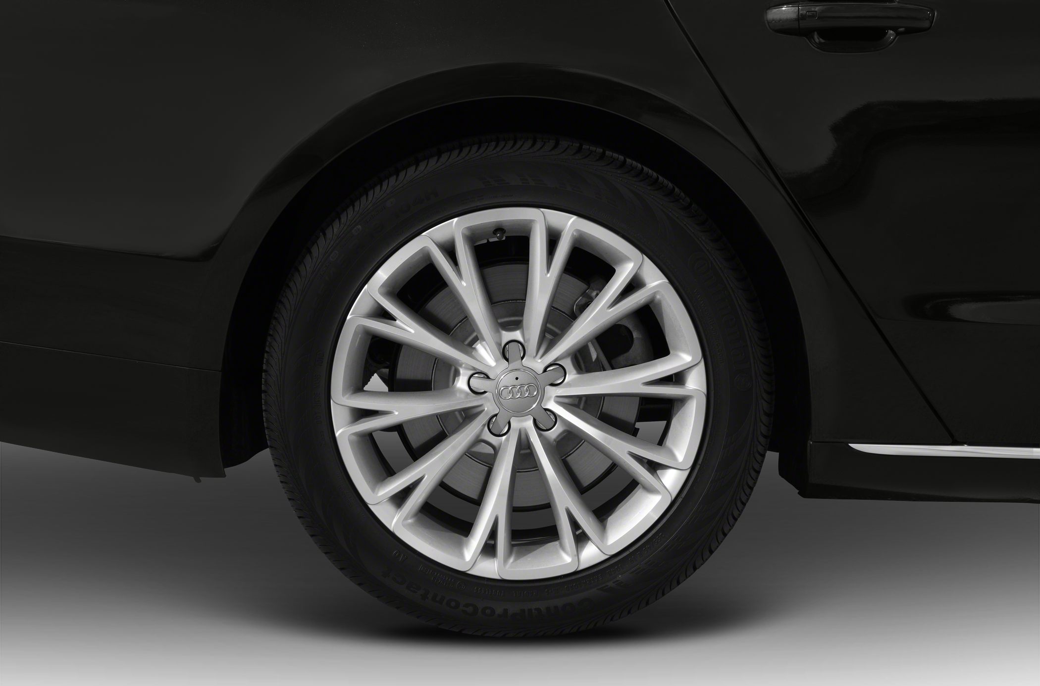 Multi-spoke alloy wheel with Continental tire on luxury sedan