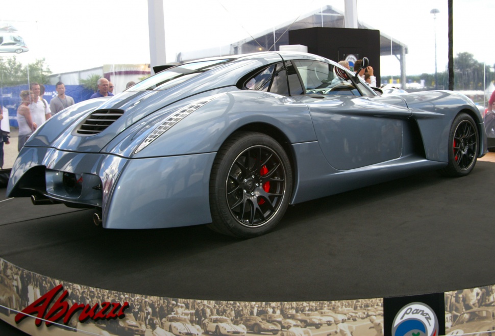 Aerodynamic rear and sleek side profile with black alloy wheels and red brake calipers.